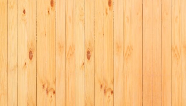 A seamless wooden panel background showcasing natural wood grain and knots, ideal for design projects.